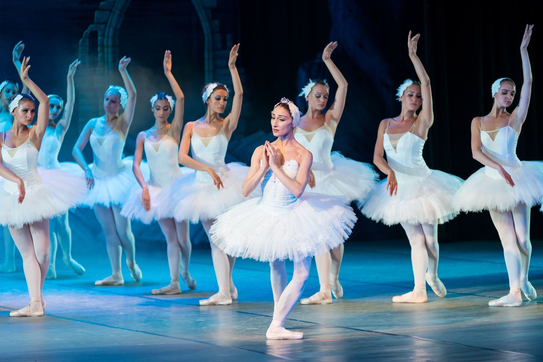 Ballet performers on a lit stage